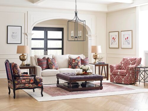 white kincaid sofa and floral acccent chairs in a living room