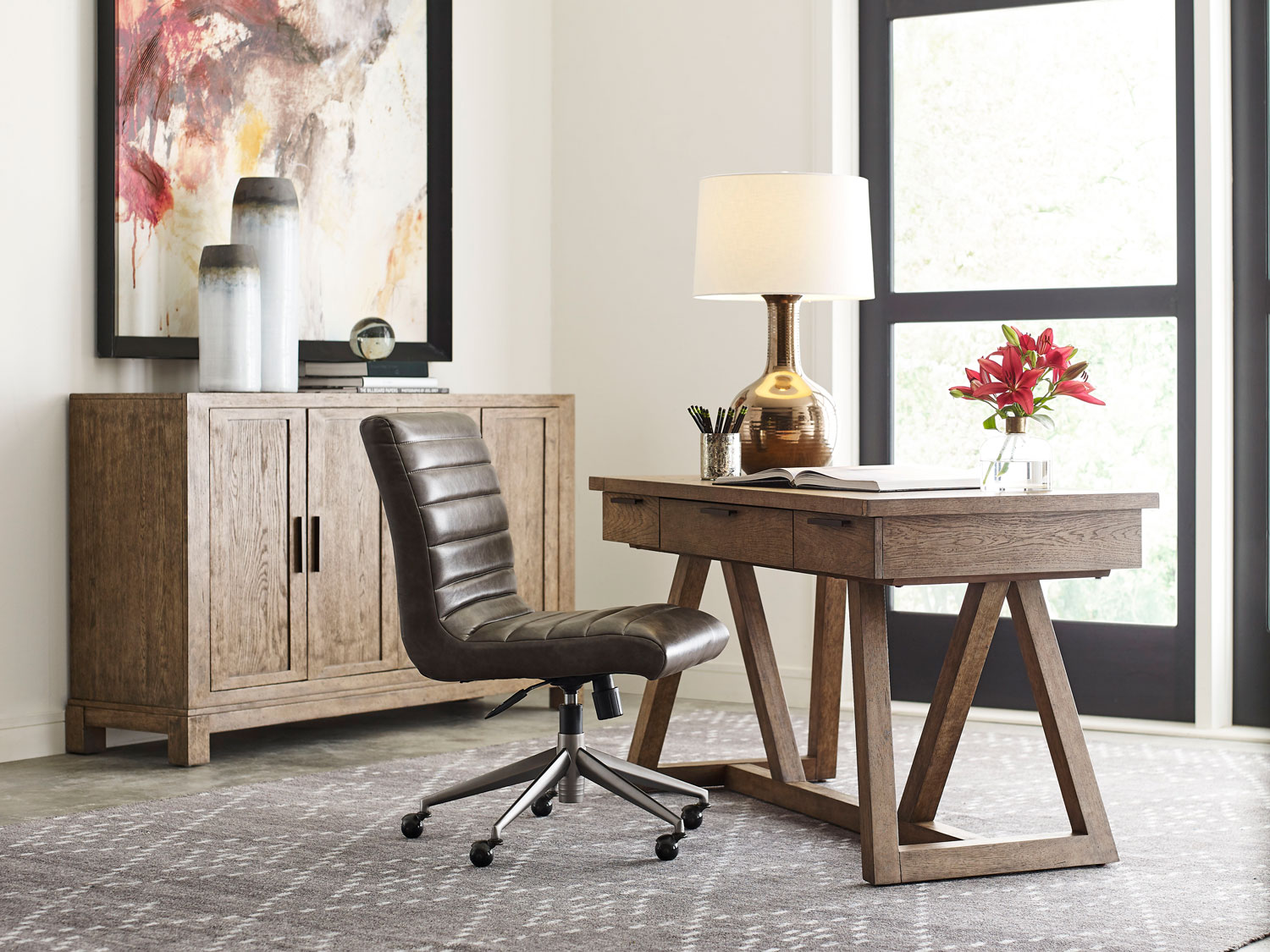 Decorate with leather office chairs. A photo of a sleek, leather office chair next to a modern wood office desk. 