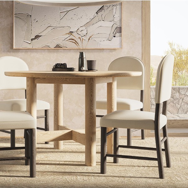 Modern dining room with a round wooden table and upholstered chairs in a neutral-toned space, featuring contemporary decor and natural textures.