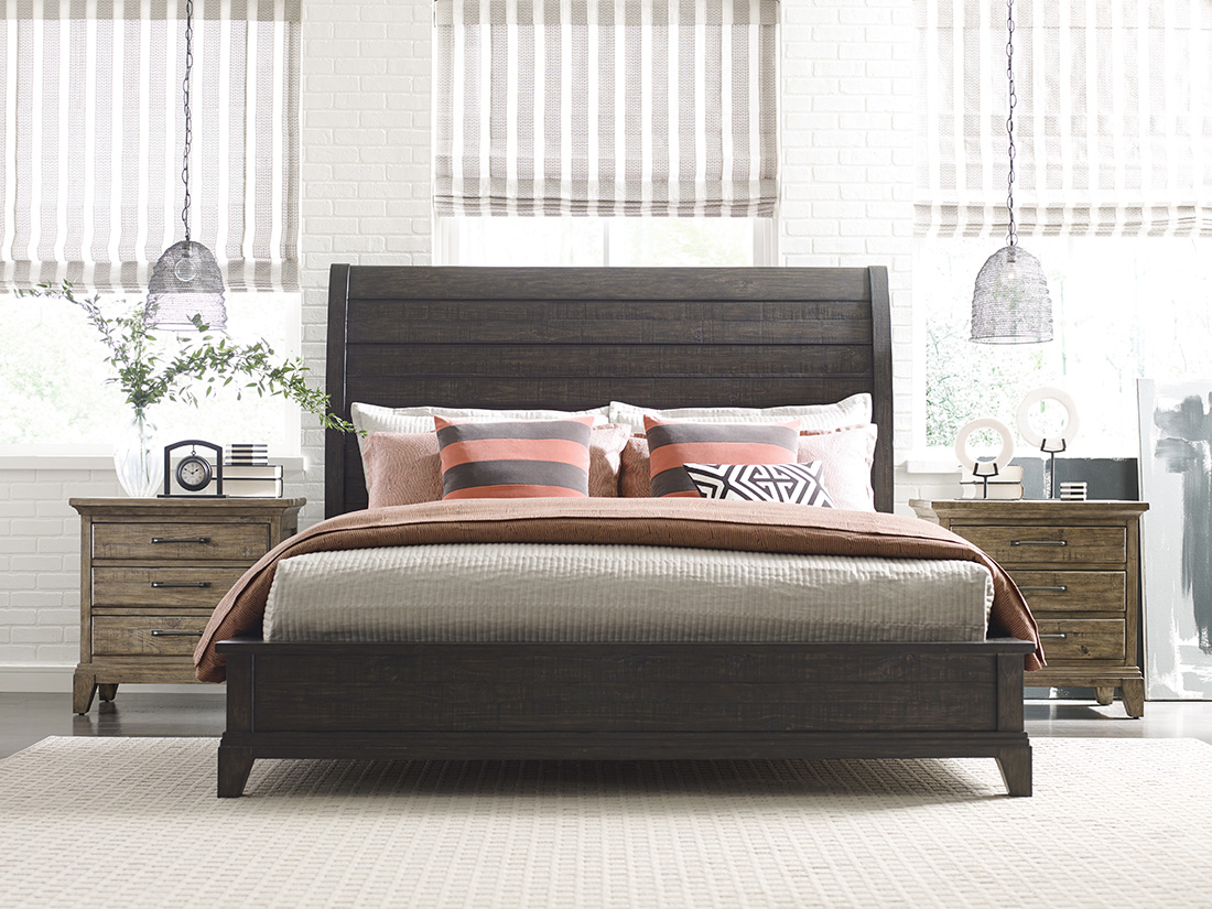 Modern bedroom showcasing mix and match bedroom furniture with a dark wood sleigh bed, rustic nightstands, and stylish decor for a warm, inviting look.